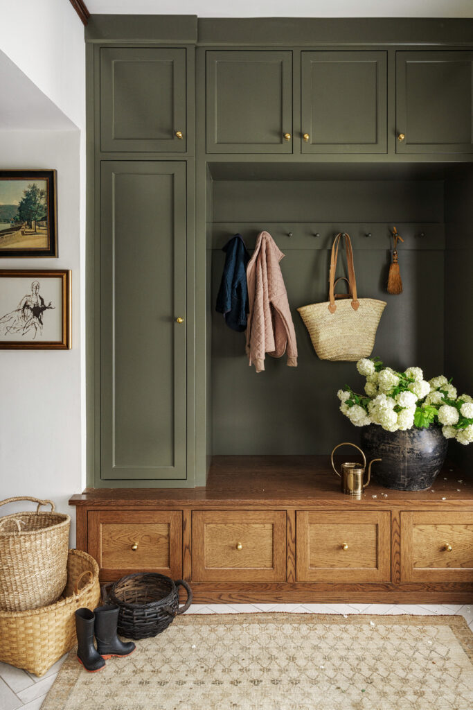 Mudroom with bench with drawers and dark olive cabinetry